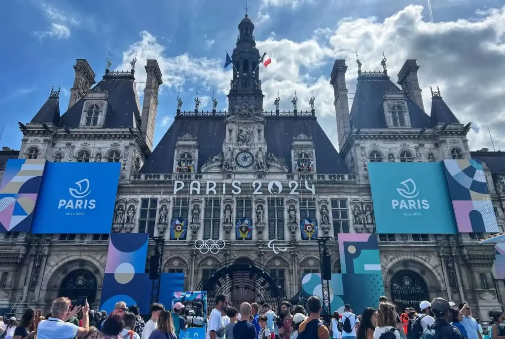 Hôtel de Ville, or City Hall, of Paris dressed up for the Paris 2024 Olympics on a sunny August afternoon with light clouds