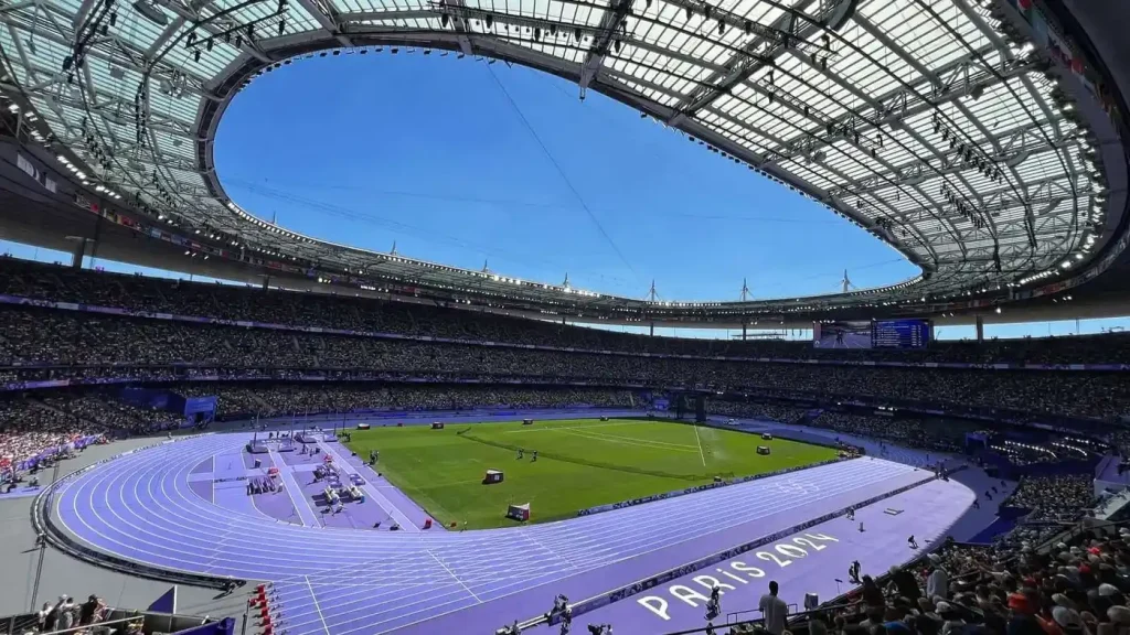 Interior of the Stade de France preparing for track and field events during the Paris 2024 Olympics on a sunny and clear August morning