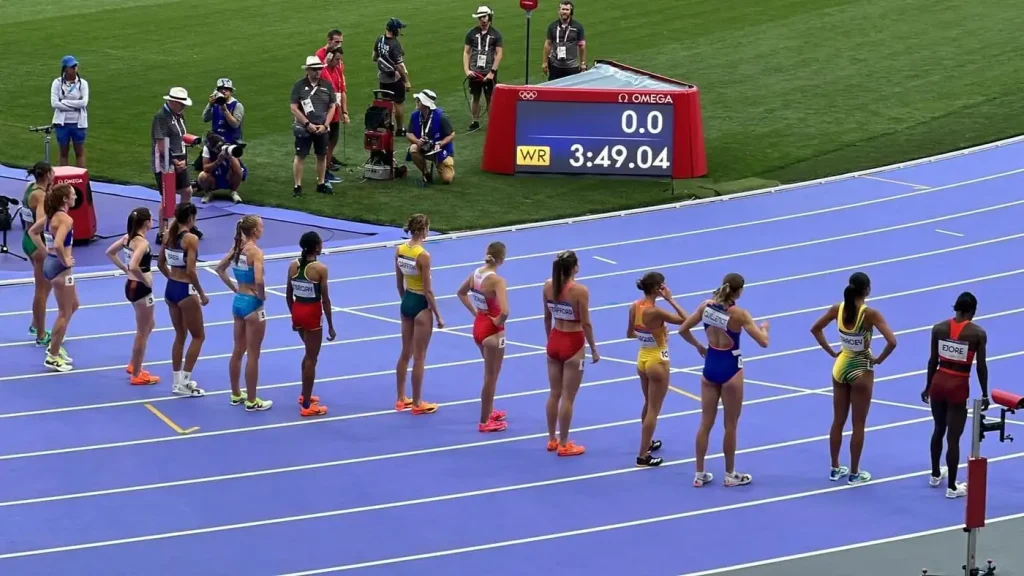 1500 meter women runners lining up for start at Paris 2024 Olympics at the Stade de France
